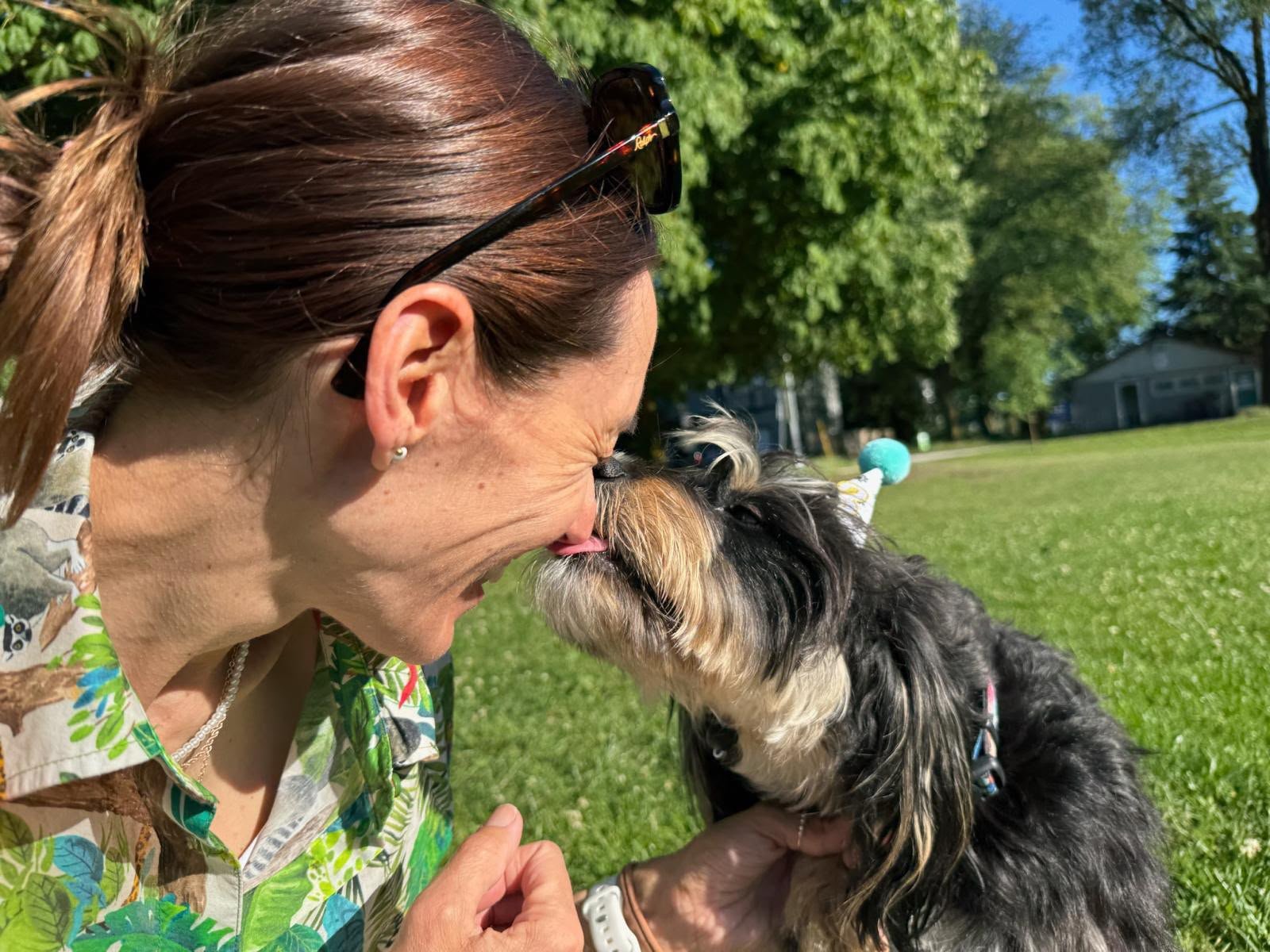Michelle sharing an affectionate moment with a Dorenlee dog outdoors